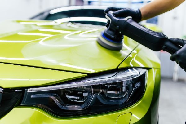 Technician applying ceramic coating to a car
